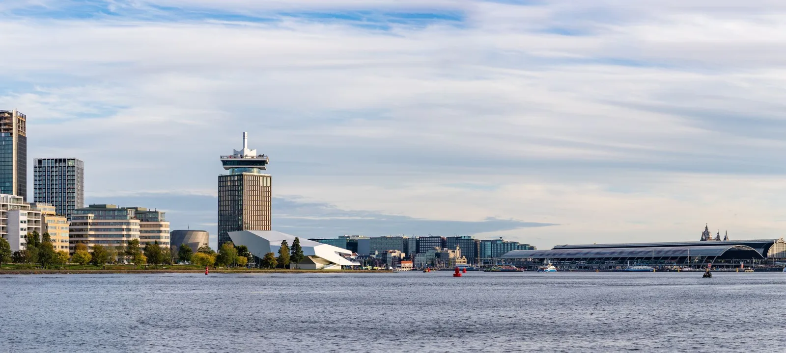 Amsterdam seen from the water: the A'DAM tower, EYE museum and Central Station along the IJ