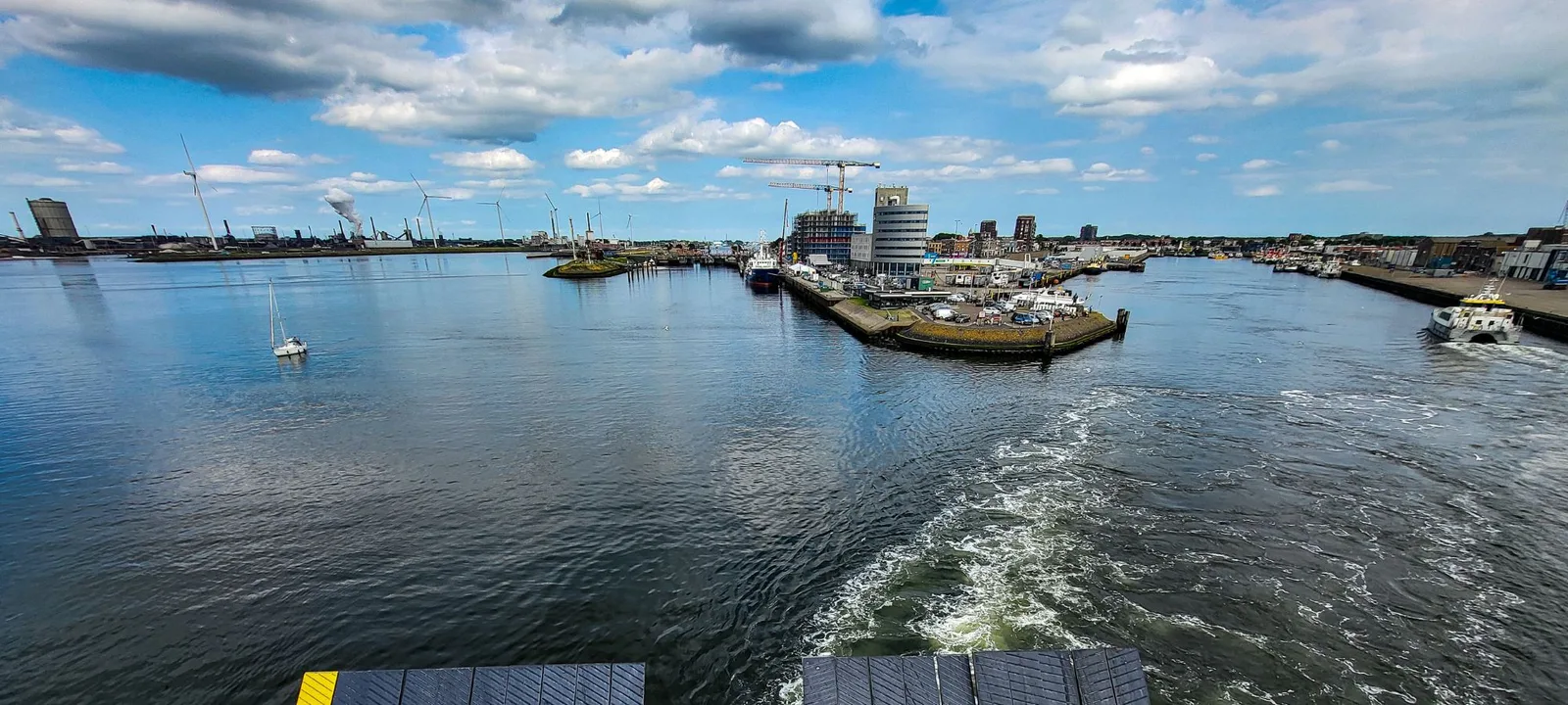 Leaving the harbour at the start of the crossing to the Netherlands, wind turbines along the shore