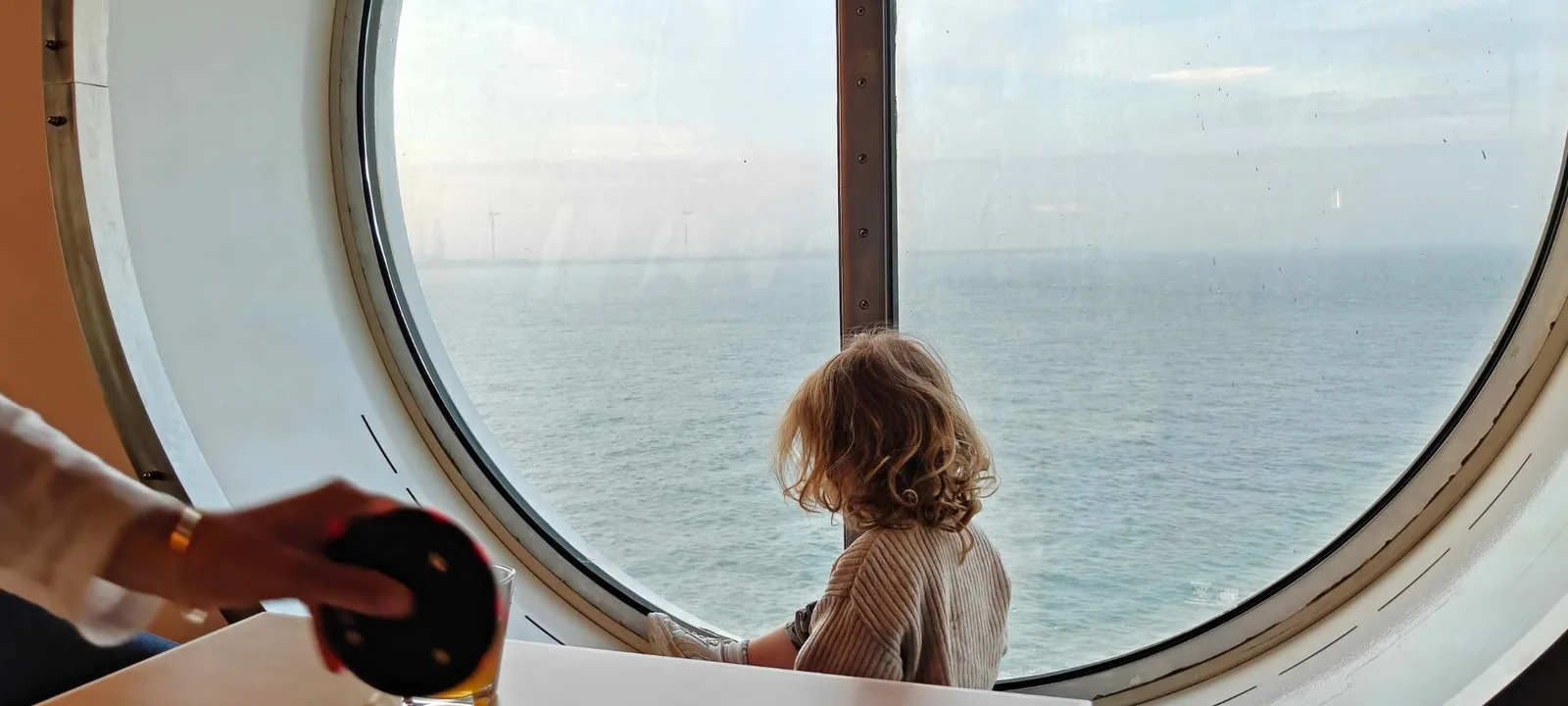 Looking out over the North Sea through a round window aboard the Harwich to Hook of Holland ferry
