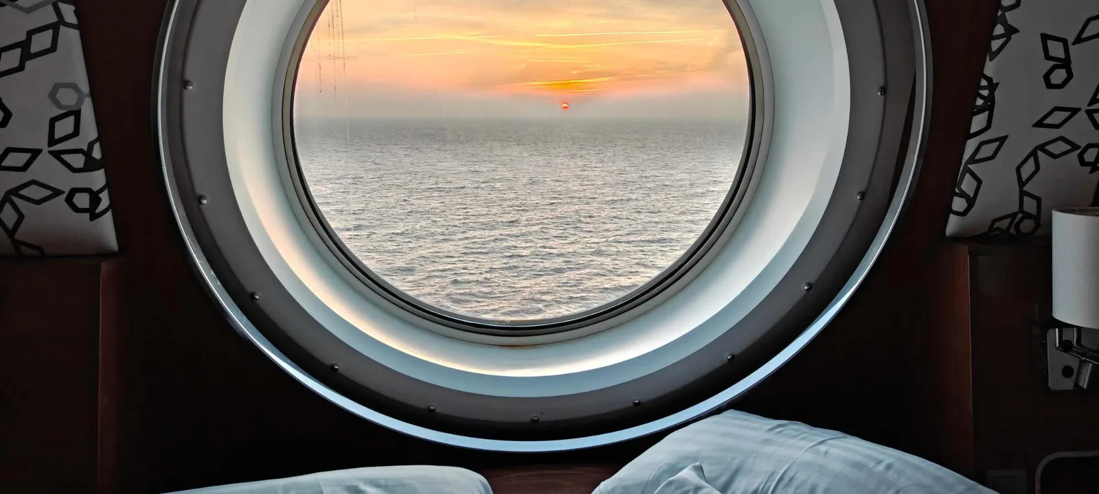 Sunset over the North Sea through a cabin porthole on the overnight ferry