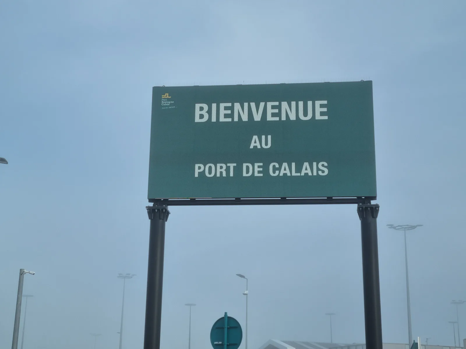 The sign on the way out at Calais; Amsterdam is around 215 miles away